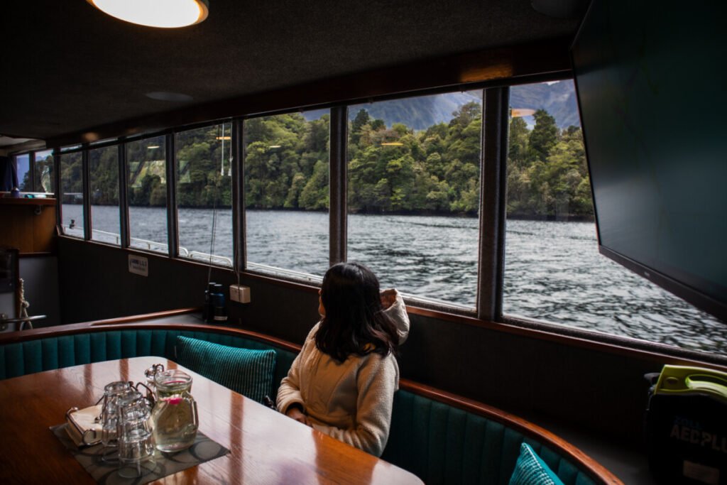 Doubtful Sound overnight cruise cabin view in New Zealand with lake and mountains