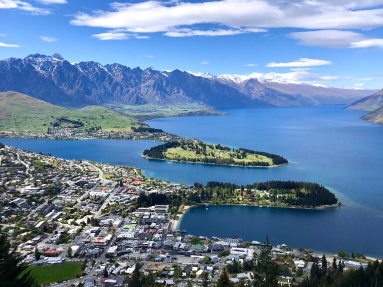 Aerial view of Queenstown, New Zealand, showing Lake Wakatipu, the Remarkables mountain range, and the town below — a helpful overview for anyone researching where to stay in Queenstown