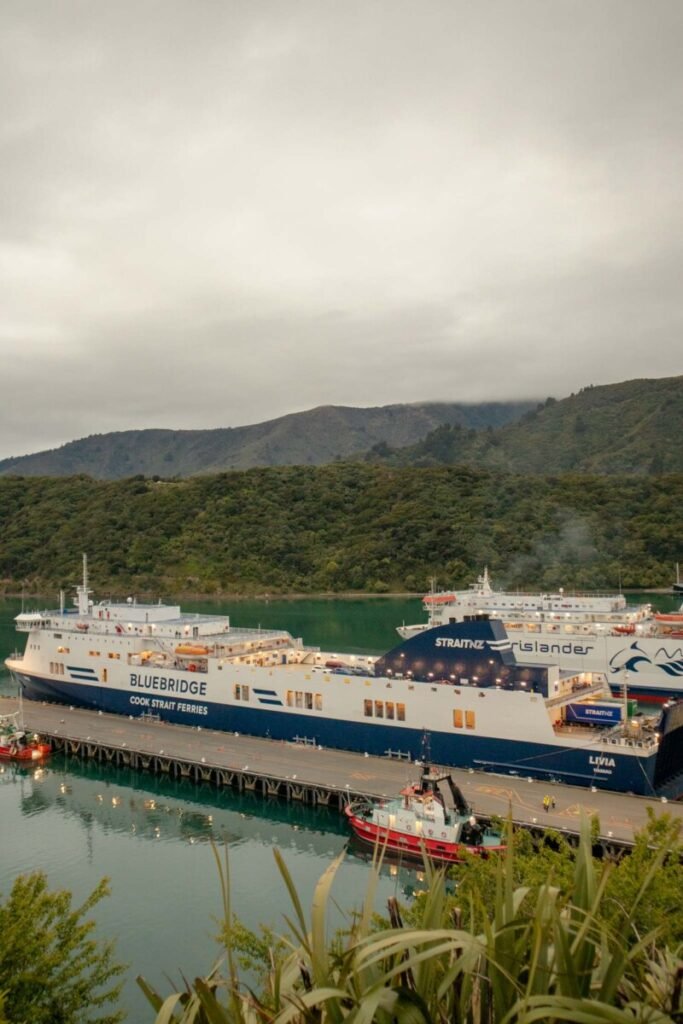 Bluebridge Cook Strait ferry and Straitsman Islander docked at Picton harbour in the Marlborough Sounds with green hills in the background