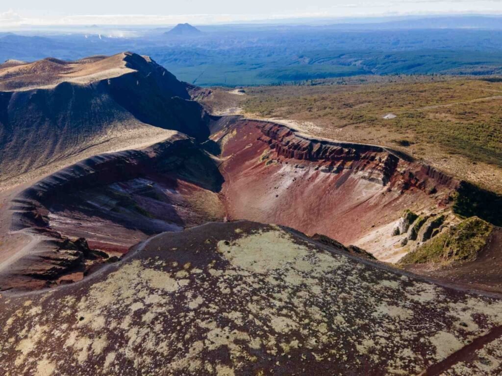 The dramatic red volcanic ridgeline of Mount Tarawera showing the raw volcanic terrain hikers traverse on the guided crater walk