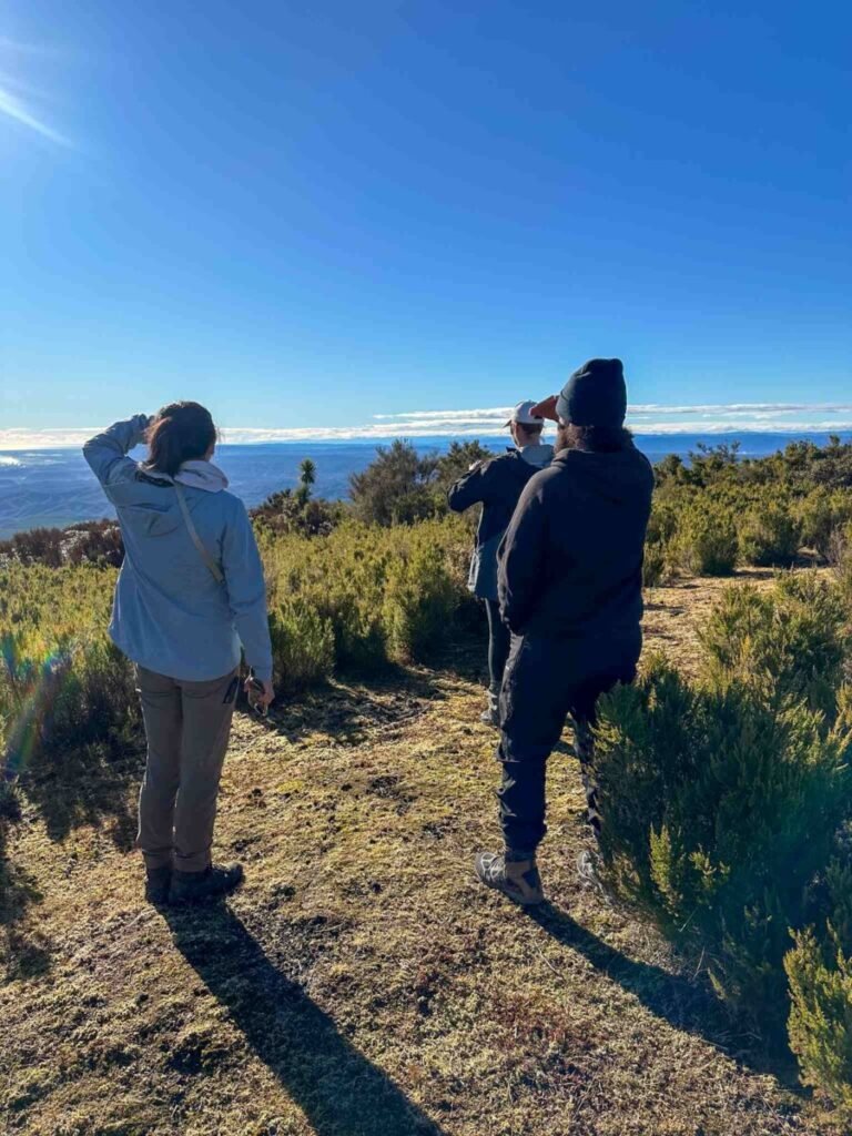 Hiker standing and looking out over the rugged volcanic landscape of Mount Tarawera before the hike begins, Rotorua New Zealand