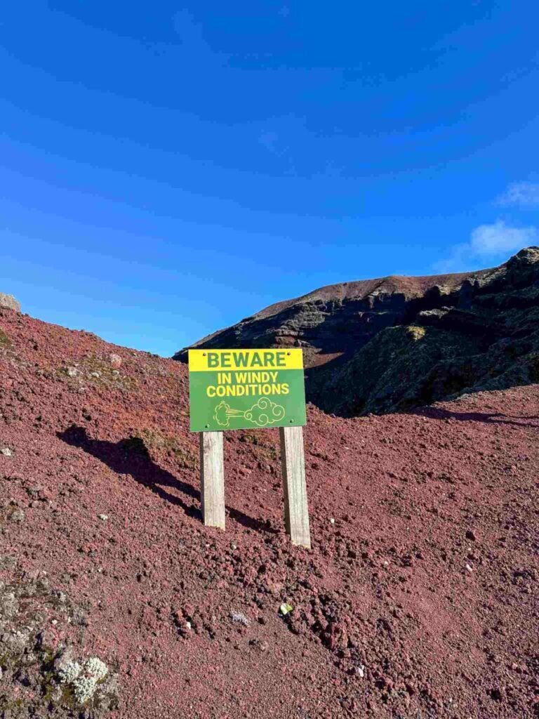 Trail marker sign on the Mount Tarawera volcanic ridge, marking the route of the guided Kaitiaki Adventures hike near Rotorua