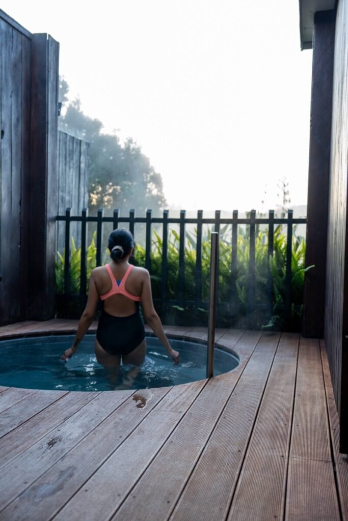 Natural thermal pool at Waikite Valley hot springs near Rotorua surrounded by lush green landscape