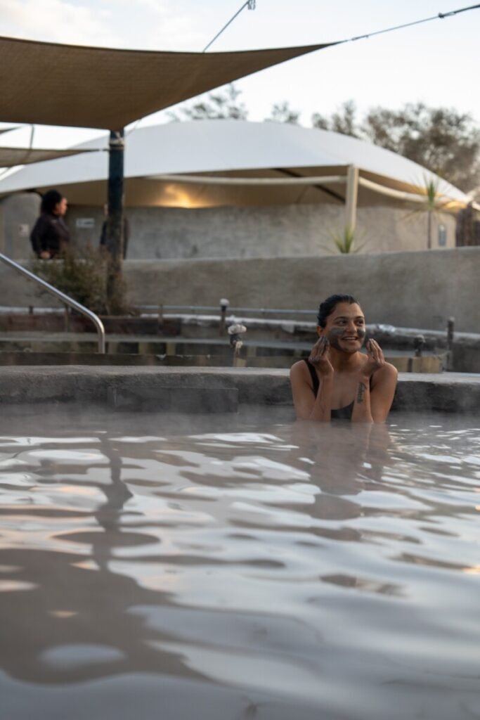 Steaming geothermal mud pools at Hell's Gate mud spa and thermal park Rotorua New Zealand