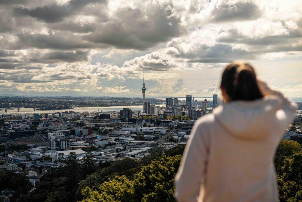 A woman looking at the Auckland skyline from Mt Eden Summit