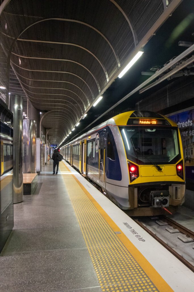 Auckland electric train arriving at a platform, part of the AT Metro rail network