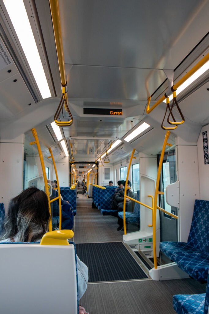 Passengers seated inside an Auckland Metro train carriage