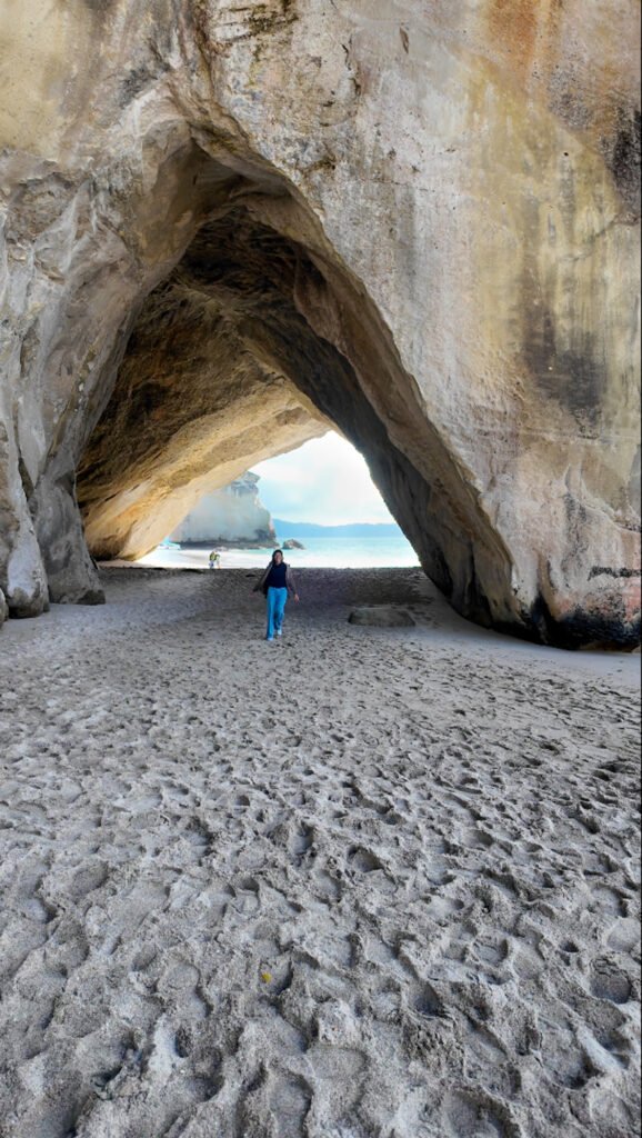 Walking through the Cathedral Cove rock archway onto the beach, Coromandel Peninsula, New Zealand