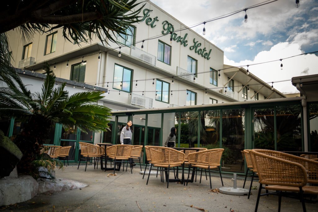 Exterior of Jet Park Hotel near Auckland Airport with outdoor courtyard seating
